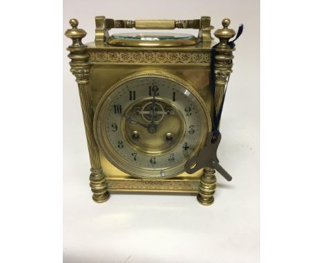 A dual  brass cased barometer / mantel clock inset with compass the silver chapter ring with Arabic Numerals and visible move