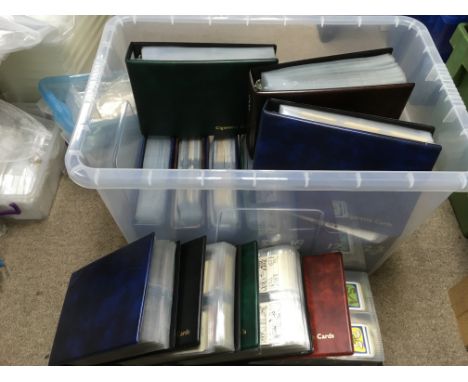 A collection of postcards, playing cards and trading cards in binders.