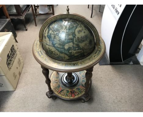 A free standing illustrated astrology globe of the world with compass design base on casters. Height approx 97cm.