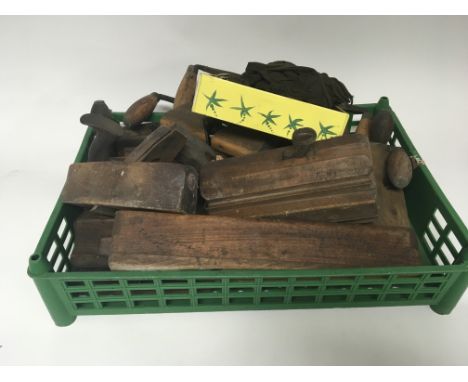 A collection of old wooden woodwork plains and tools
