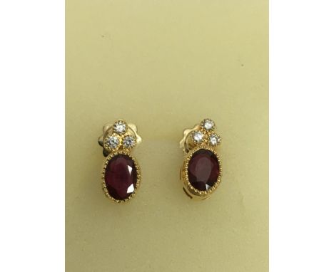 A pair of 18ct gold ruby and diamond set earrings