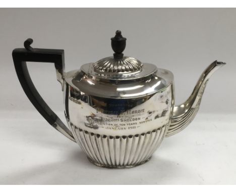 A silver teapot with half gadrooned decoration, Sheffield hallmarks.