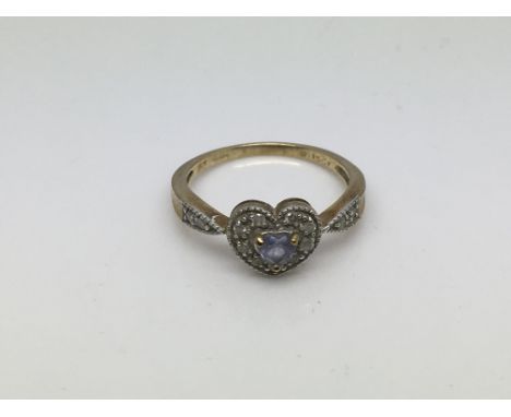 A 9ct gold ring set with a central heart shaped aquamarine surrounded by small diamonds, approx 2.7g and approx size P.