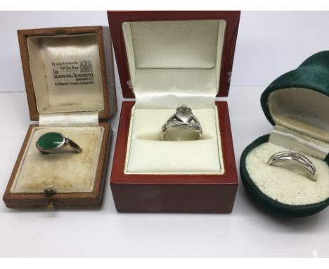 Three silver rings in boxes, one with a jade type stone - NO RESERVE