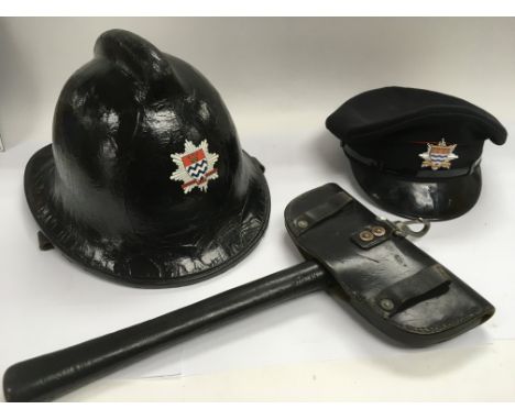 A collection of Fire service items comprising a vintage axe, helmet and hat.