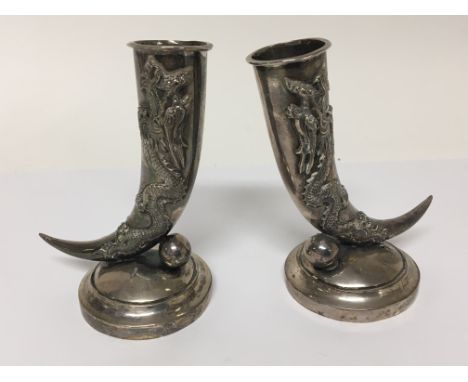 A pair of Chinese silver spill vases decorated with dragons on circular bases stamped 90 and Marks for Wang Hee. Some repair 