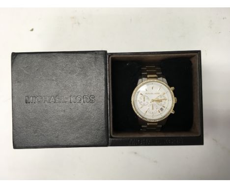 A boxed Michael Kors ladies chronograph with gold tone bezel surround.