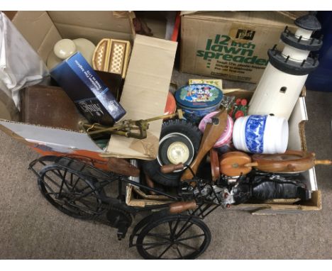 Two boxes of oddments comprising two iron models of bicycles, various tins,  a pair of scales etc.