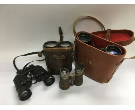 Four pairs of vintage binoculars.