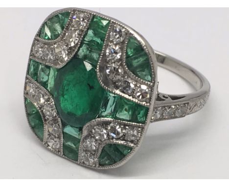 A platinum emerald and diamond Art Deco-style panel ring, boxed. Emeralds 1.85ct approx. Diamonds 0.58ct approx. Ring size M