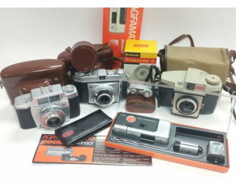 A box containing a collection of vintage cameras including Agfa and Kodak