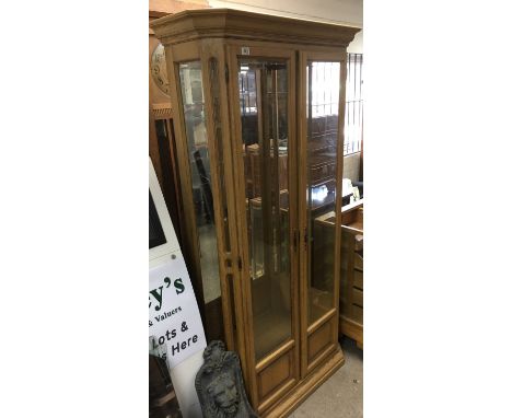 A modern, light wood display cabinet.Approx 97cmwx200hx40d