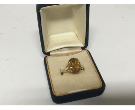 A 9carat gold ring inset with a good size cut  citrine stone. Weight 2.5g.