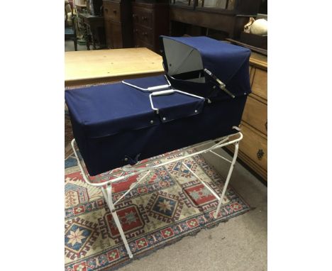 A vintage child's cot on stand.