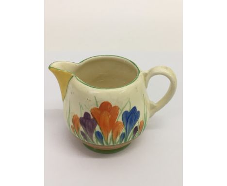 A small Clarice Cliff 'Crocus' pattern jug.Approx 8cm, possible restoration to spout.