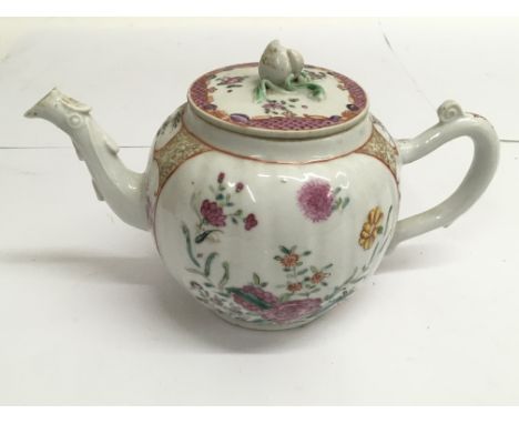 An 18th century Chinese export teapot, of lobed shape with floral painted reserves, matched lid.Approx 20cm long.