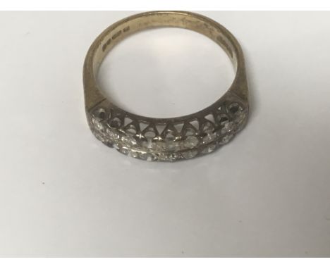 A 18 ct gold ring Inset with two rows of diamonds ( one stone missing)