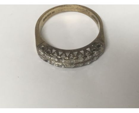 A 18 ct gold ring Inset with two rows of diamonds ( one stone missing)