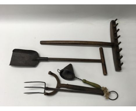 A collection of fireside tools to include a toasting fork.