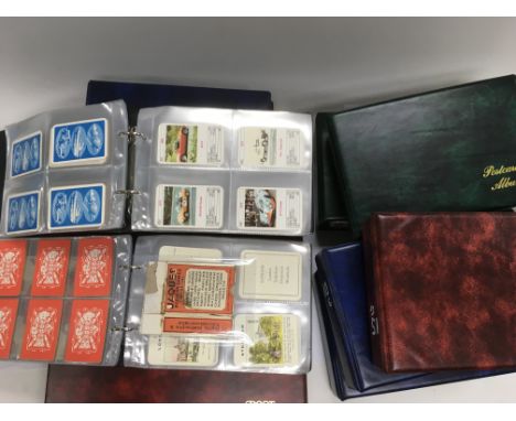 A collection in nine albums of various sets of playing card plus a an album of vintage postcrads.