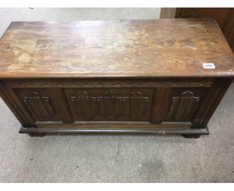 A oak blanket box with panel front