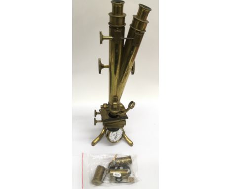 A brass microscope with duel eyepiece