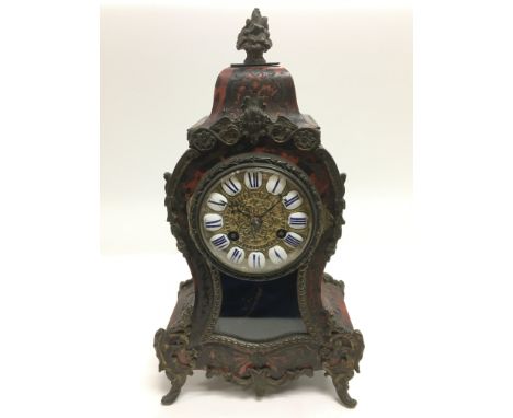A late 19th Century brass and tortoiseshell boulle mantle clock with a French movement, approx 30.5cm.