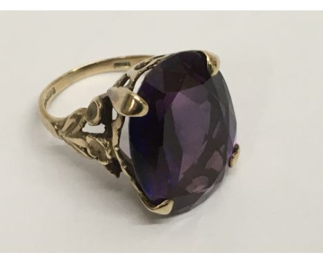 A 9ct gold ring set with large amethyst colour stone.Approx K