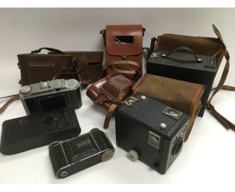 A collection of vintage cameras and accessories.