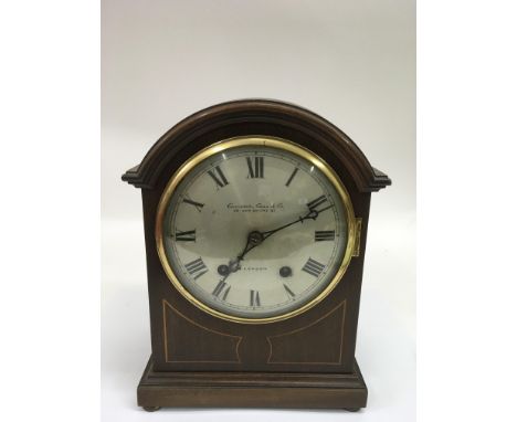 An Edwardian inlaid mantle clock by Carmerer, Cuss and Co.
