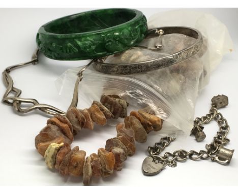 A dark green carved jade bangle together with a sliver bangle, bracelet and charm and a Baltic Amber necklace approx 30cm lon