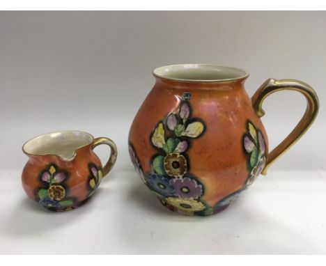 A Carltonware one handled vase decorated with flowers on an orange ground together with a matching jug.