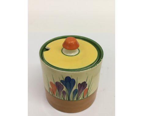 A Clarice Cliff 'Crocus' pattern preserve pot. Approx 11cm, small chip to underside of base