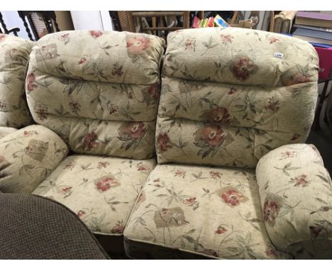 A Quality modern three piece suite comprising a two seater sofa and a pair of arm chairs in virtually unused condition.