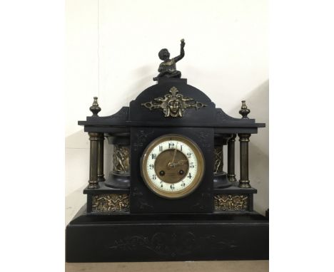 A large , T.Russell, black slate mantle clock of Classical style, surmounted by a cherub. 38x14x43cm high