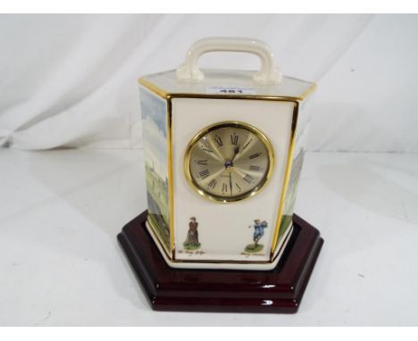 A good quality ceramic mantel clock with a golfing theme by Pointers of London and Edinburgh, set on a mahogany plinth, appro