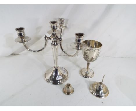 A good quality silver plated four branch candelabra 25 cm (h) and a silver plated goblet with repousse and chased decoration 