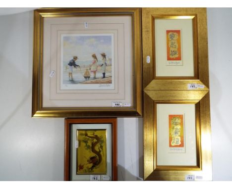 A limited edition print mounted and framed under glass depicting children on a beach numbered 327 of 500 signed in pencil by 