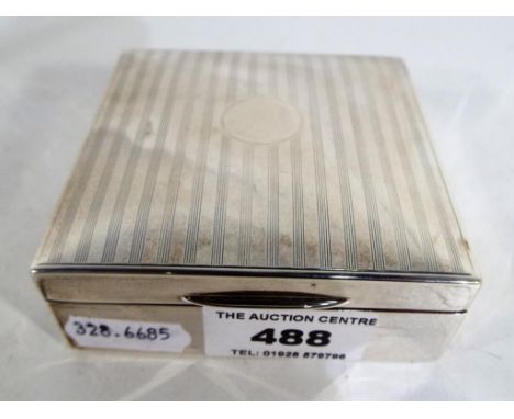 A George V silver hallmarked, cedar lined cigarette box of square form, engine turned decoration to the lid with vacant circl