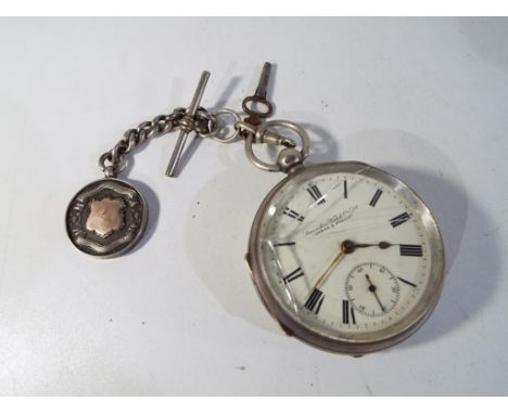 A hallmarked silver cased pocket watch, Chester assay 1901, Roman numerals on a white dial scribed Lancashire Watch Co, key w