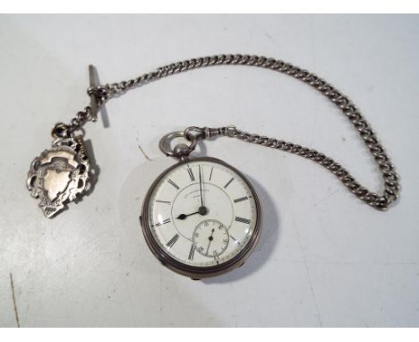 A hallmarked silver cased pocket watch, Chester assay 1890, Roman numerals on a white dial scribed Wm Winstanley, Wigan (reta