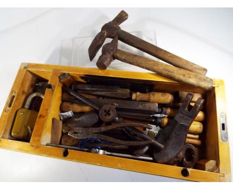 A box containing 25 metal and wood working tools (files, hammer, chip hammer and other) some of them with hand made handles, 