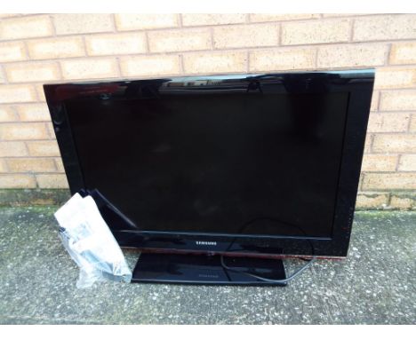 A Samsung 31inch flat screen television, model #LE32B530P7W with power lead, remote control and related ephemera / manual 