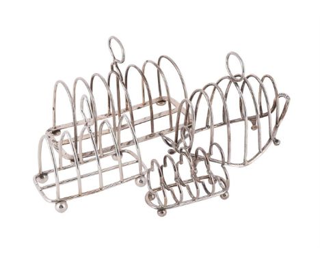 
	
		FOUR SILVER TOAST RACKS
		To include: an Edwardian six division toast rack by Charles &amp; George Asprey, London 1909, 