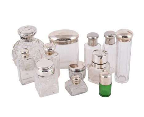 
	
		A COLLECTION OF GLASS DRESSING TABLE JARS AND BOTTLES
		To include: an Edwardian globular cut glass bottle with silver m