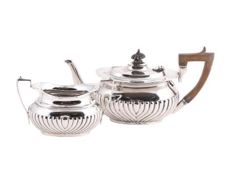 
	
		AN EDWARDIAN SILVER OBLONG BALUSTER TEA POT AND SUGAR BOWL
		BOARDMAN, GLOSSOP &amp; CO. LTD., BIRMINGHAM 1904
		The tea