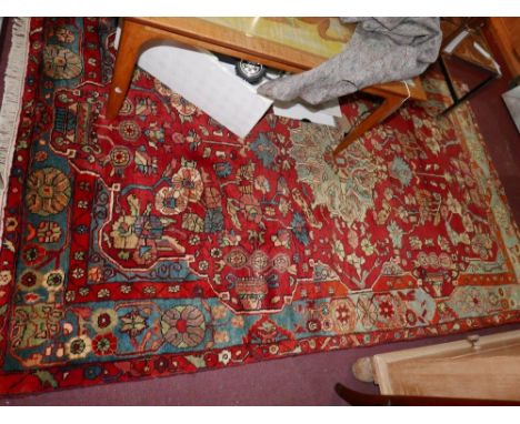 A North West Persian Nahawand rug, central diamond pole medallion with repeating spandrels on a rouge field, guarded by a sty