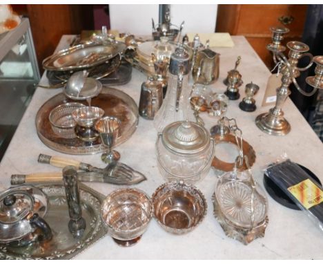 A collection of silver plated items to include a glass claret jug, a candelabra, trays, cutlery etc 