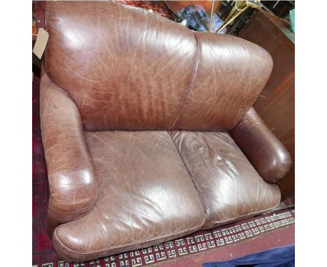 A contemporary brown leather two seater sofa 