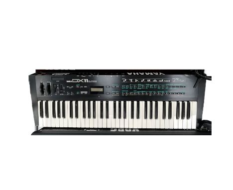 A studio used instrument, ‘Yamaha DX 11 Digital Programmable Algorithm Synthesiser’ keyboard and power lead.  9kg 91x29.5x10c
